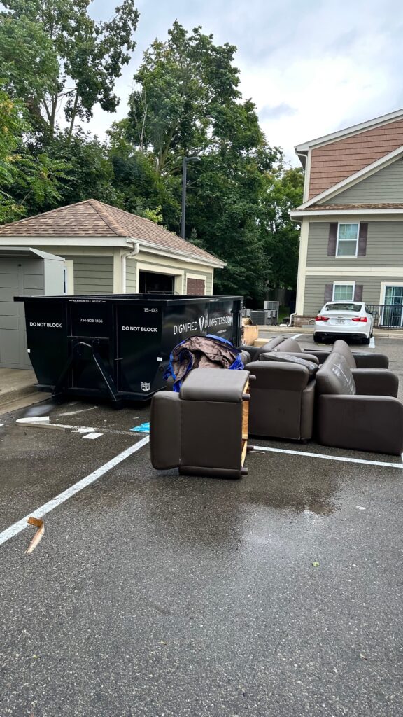 Alt Text: loading furniture into 15 yard dumpster