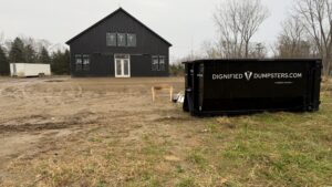 Contractor using a roll-off dumpster during a residential remodeling project in Ann Arbor, Michigan
