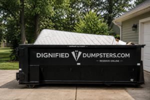 Old mattress being loaded into a residential dumpster in Michigan.